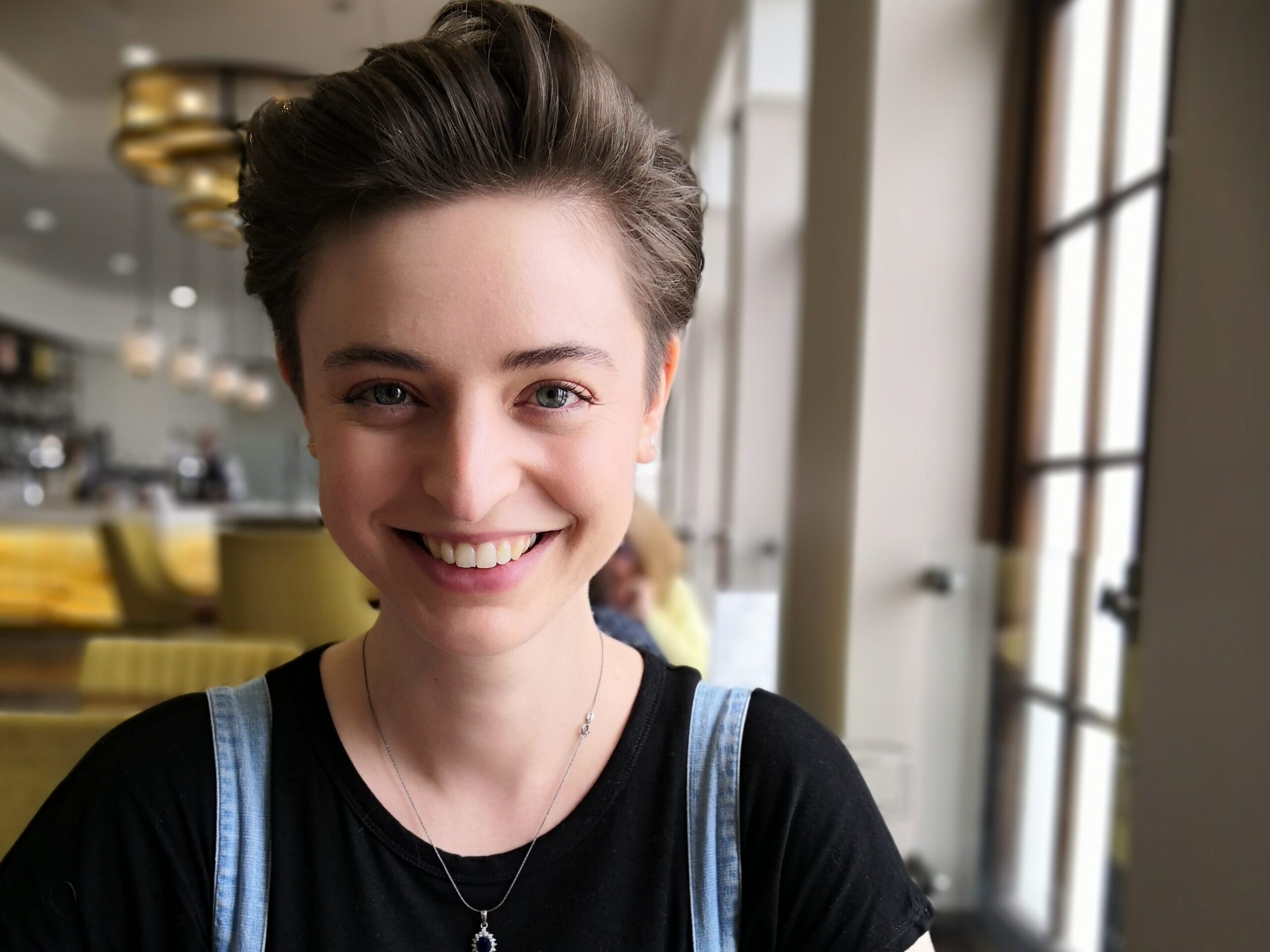 Photo of Emily Holyoake, a white woman with short brown hair, smiling